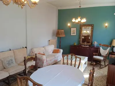 a living room with a couch and a table at Family Athens, Enjoy Athens in Athens