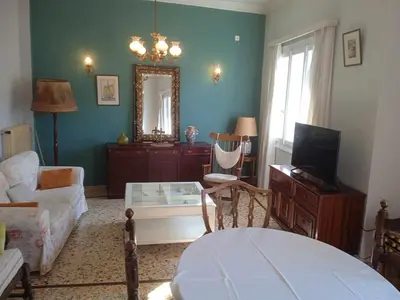 a living room with a couch a table and a mirror at Family Athens, Enjoy Athens in Athens