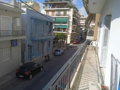 a city street with cars parked on the street at Family Athens, Enjoy Athens in Athens