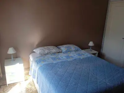 a bedroom with a bed with a blue comforter and two lamps at Family Athens, Enjoy Athens in Athens