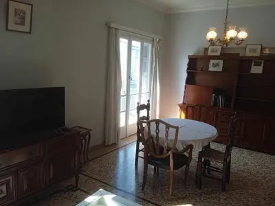 a living room with a table and chairs and a television at Family Athens, Enjoy Athens in Athens
