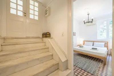 a bedroom with stairs and a bed in a room at zen-amazing, exarchia in Athens