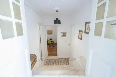 a hallway with white walls and a white stairway at zen-amazing, exarchia in Athens
