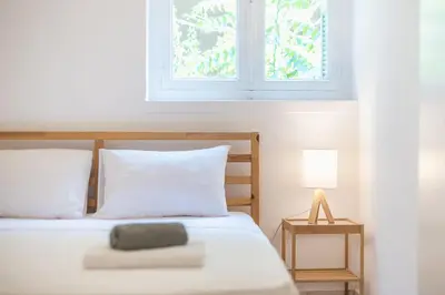 a bedroom with a white bed with a window at zen-amazing, exarchia in Athens