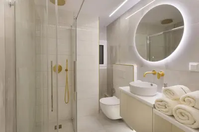 a bathroom with a toilet and a sink and a mirror at Elegant minimal studio in Kerameikos in Athens