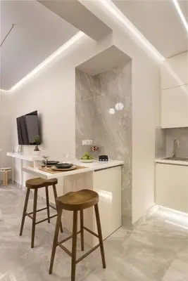 a kitchen with a counter and two stools and a table at Elegant minimal studio in Kerameikos in Athens