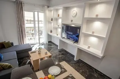 a living room with a couch and a flat screen tv at Newly Renovated 2-Bedroom Condo In Athens ! in Athens