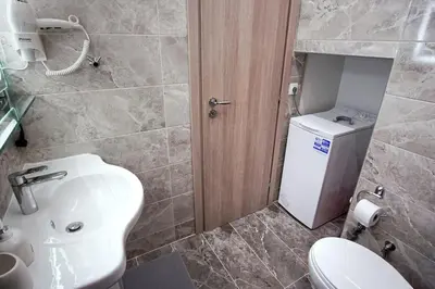 a bathroom with a white sink and a toilet at Newly Renovated 2-Bedroom Condo In Athens ! in Athens