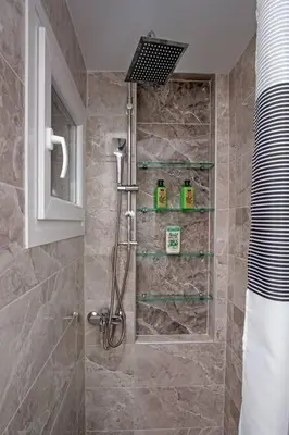 a bathroom with a shower with a glass door at Newly Renovated 2-Bedroom Condo In Athens ! in Athens