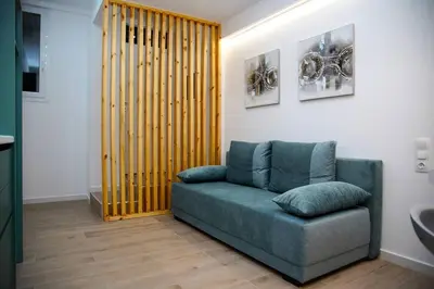 a living room with a blue couch in a room at Private Athens Retreat VIPGreece in Athens