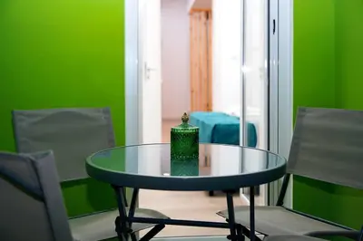 a glass table in a room with two chairs at Private Athens Retreat VIPGreece in Athens