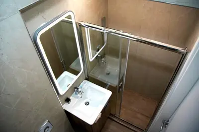 a bathroom with a sink and a shower and a mirror at Private Athens Retreat VIPGreece in Athens
