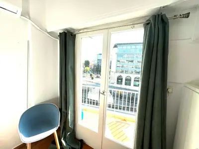 a room with a window with a green curtain at Athens Koukaki Apartment in Athens