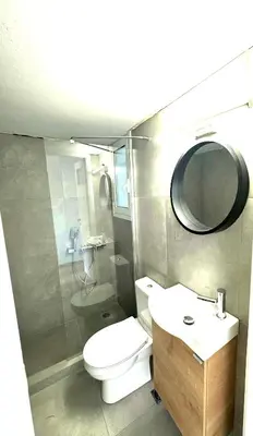 a bathroom with a toilet and a sink and a mirror at Athens Koukaki Apartment in Athens