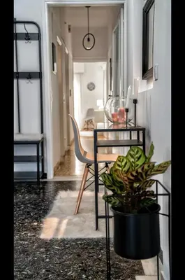 a dining room with a table and a plant at Luxury Apartment near Acropolis in the Heart of Athens in Athens