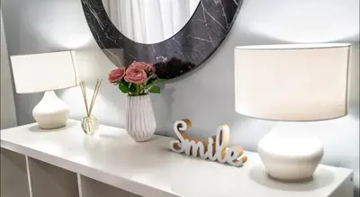 a white table with two lamps and a mirror at Luxury Apartment near Acropolis in the Heart of Athens in Athens
