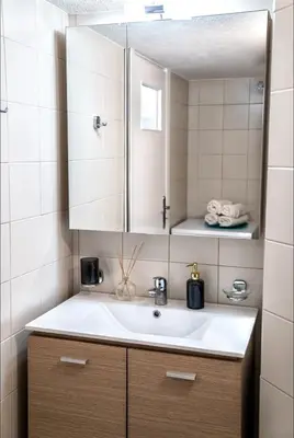 a bathroom with a sink and a mirror at Luxury Apartment near Acropolis in the Heart of Athens in Athens
