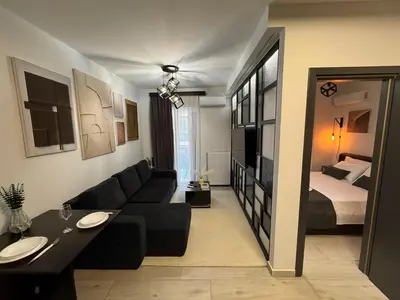 a living room with a couch and a bed at Modern Apartment with Free Parking and 300Mbps Internet in Athens