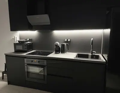 a kitchen with a stove and a sink at Modern Apartment with Free Parking and 300Mbps Internet in Athens