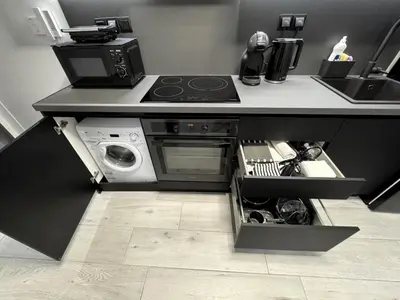 a kitchen with a stove top oven next to a sink at Modern Apartment with Free Parking and 300Mbps Internet in Athens