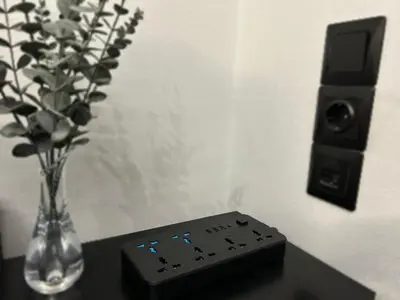a remote control sitting on a table with a vase of flowers at Modern Apartment with Free Parking and 300Mbps Internet in Athens