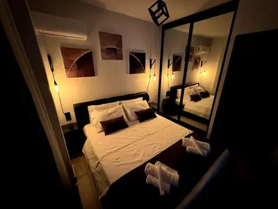 a bedroom with a bed and a large mirror at Modern Apartment with Free Parking and 300Mbps Internet in Athens