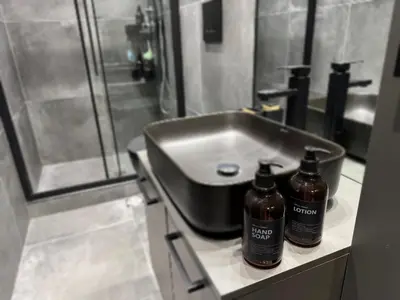two bottles sitting on a counter next to a sink at Modern Apartment with Free Parking and 300Mbps Internet in Athens