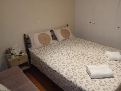 a bedroom with a bed with two towels on it at Casa d Irene - 5th Floor, Balcony Views, Metro Steps Away in Athens