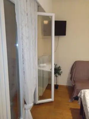 a glass door with a mirror in a living room at Casa d Irene - 5th Floor, Balcony Views, Metro Steps Away in Athens