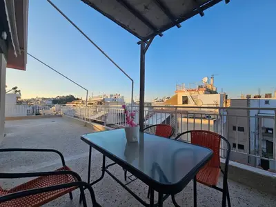 a table and chairs on a balcony with a view at Casa d Irene - 5th Floor, Balcony Views, Metro Steps Away in Athens
