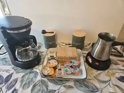 a table topped with a coffee maker and a tray of food at Casa d Irene - 5th Floor, Balcony Views, Metro Steps Away in Athens