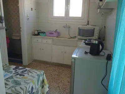 a small kitchen with a sink and a microwave at Casa d Irene - 5th Floor, Balcony Views, Metro Steps Away in Athens