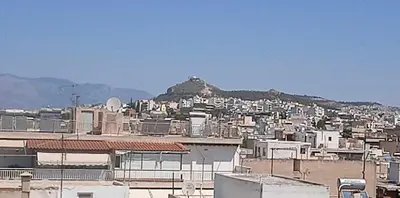 a city with buildings and a mountain in the background at Casa d Irene - 5th Floor, Balcony Views, Metro Steps Away in Athens