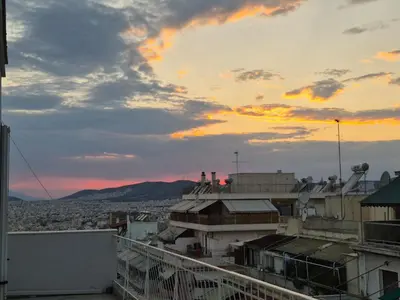 a view from the roof of a building at sunset at Chic penthouse with stunning view in Athens