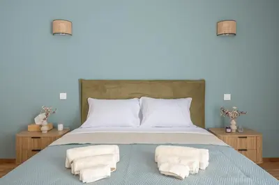 a bedroom with a bed with two towels on it at Chic penthouse with stunning view in Athens
