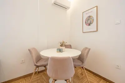 a white table and chairs in a room at Chic penthouse with stunning view in Athens