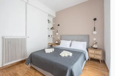 a bedroom with a bed with two towels on it at Chic penthouse with stunning view in Athens