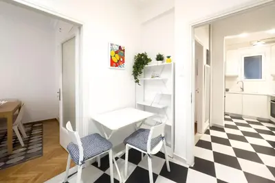 a kitchen with a black and white checkered floor at Art & Comfort Apartment in Athens in Athens