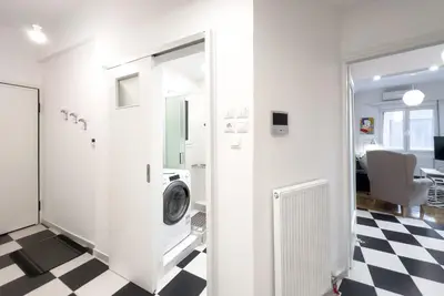 a bathroom with a washing machine in a room at Art & Comfort Apartment in Athens in Athens