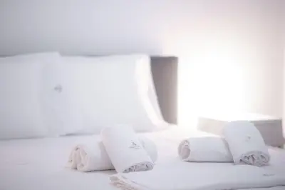 three towels on a bed in a hotel room at Art & Comfort Apartment in Athens in Athens