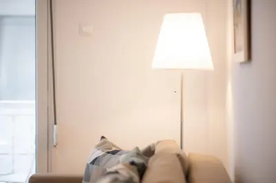 a living room with a couch and a lamp at Art & Comfort Apartment in Athens in Athens