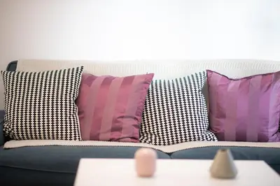 a blue couch with pillows on top of it at Art & Comfort Apartment in Athens in Athens