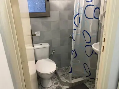 a small bathroom with a toilet and a sink at koukaki nest in central athens in Athens