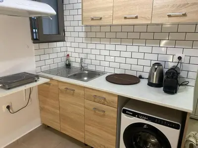 a kitchen with a sink and a washing machine at koukaki nest in central athens in Athens