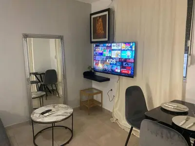 a living room with a flat screen tv on the wall at koukaki nest in central athens in Athens