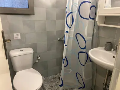 a small bathroom with a toilet and a sink at koukaki nest in central athens in Athens
