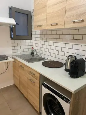 a kitchen with a sink and a washing machine at koukaki nest in central athens in Athens