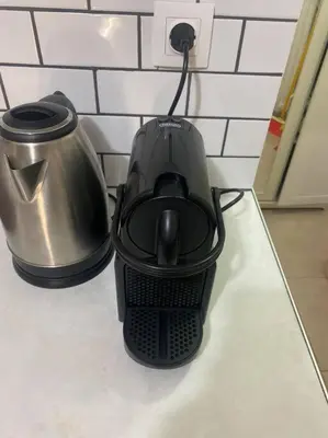 a black blender sitting on a counter next to a pot at koukaki nest in central athens in Athens