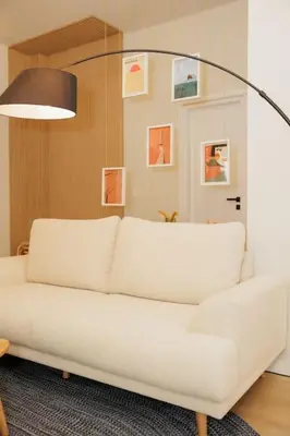 a white couch in a living room with a lamp at Modern 2BDR apartment in Pagrati in Athens