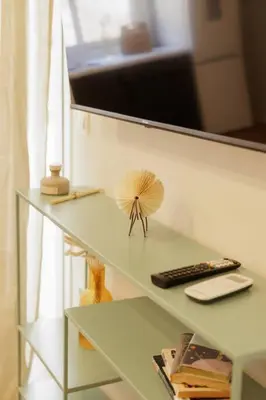 a book shelf with a fan on top of it at Modern 2BDR apartment in Pagrati in Athens